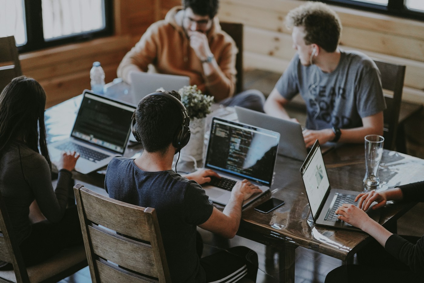 Software team collaborating around a shared work table