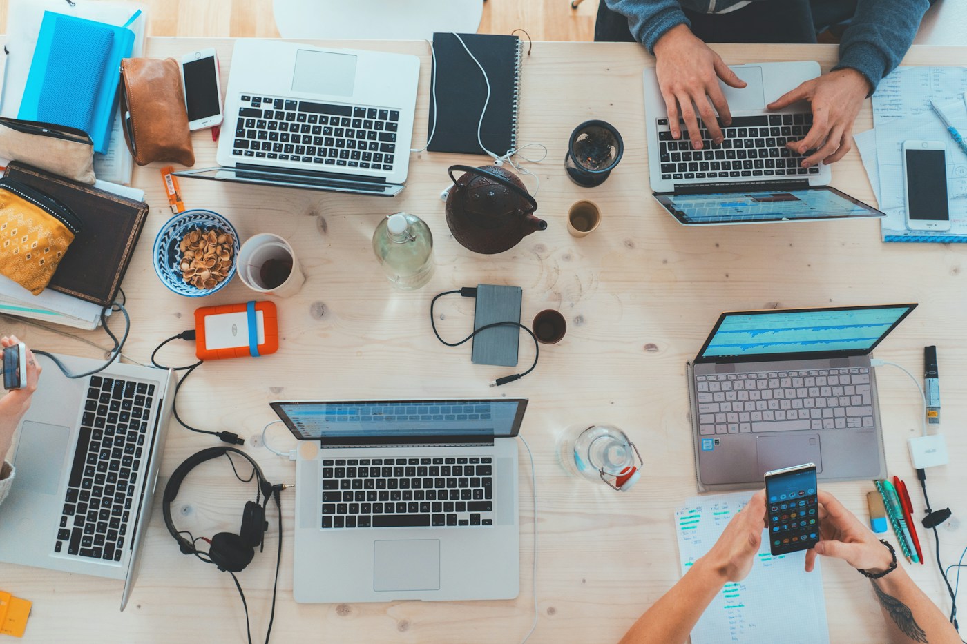 People coordinating work around laptops