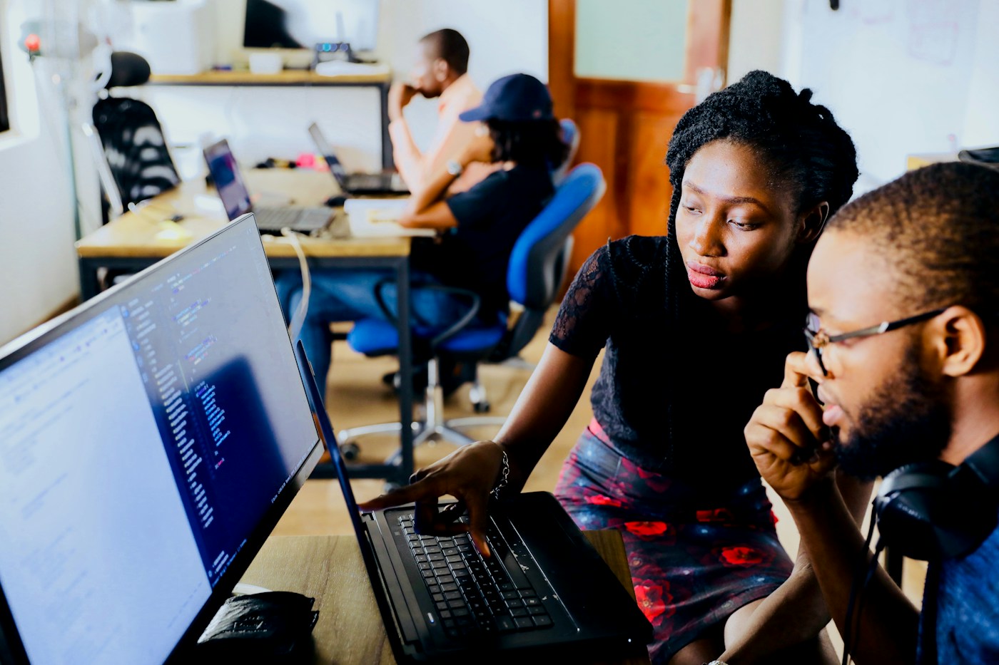 Colleagues reviewing work together at a computer